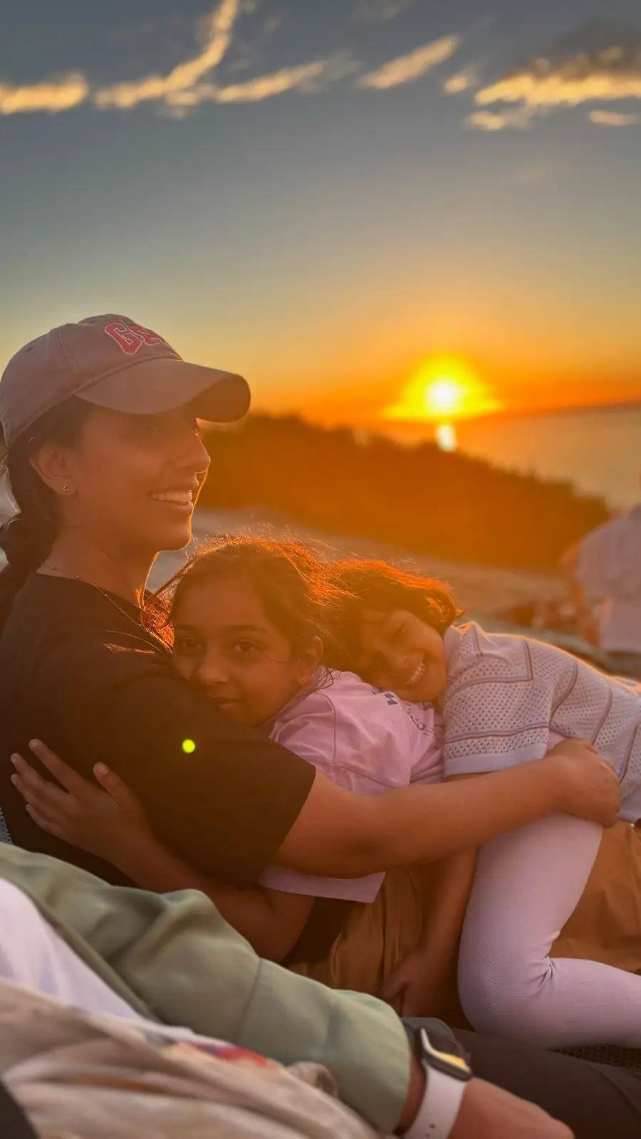 Dr Vally watching the sunset with her daughters — life outside the chair